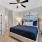 Bedroom with bed, ceiling fan, and closet