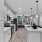  A modern kitchen with white cabinets and a large island.