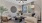  A living room with a beige couch, a wooden chair, a coffee table, and a ceiling fan.